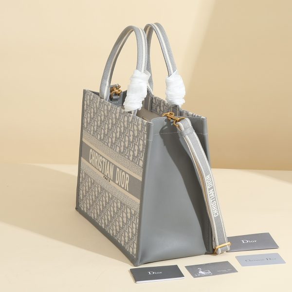 a1720369072657_4457 This book tote handbag was designed by Maria Grazia Chiuri, Creative Director of Dior Women's Wear