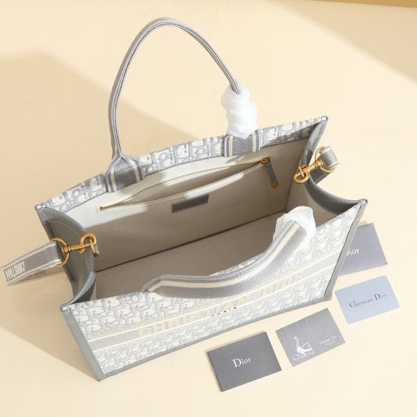 a1720369072720_7785 This book tote handbag was designed by Maria Grazia Chiuri, Creative Director of Dior Women's Wear