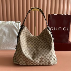 The Gucci Beatrix handbag collection is crafted with black cowhide material and adorned with iconic horseneck buckle details on the shoulder strap