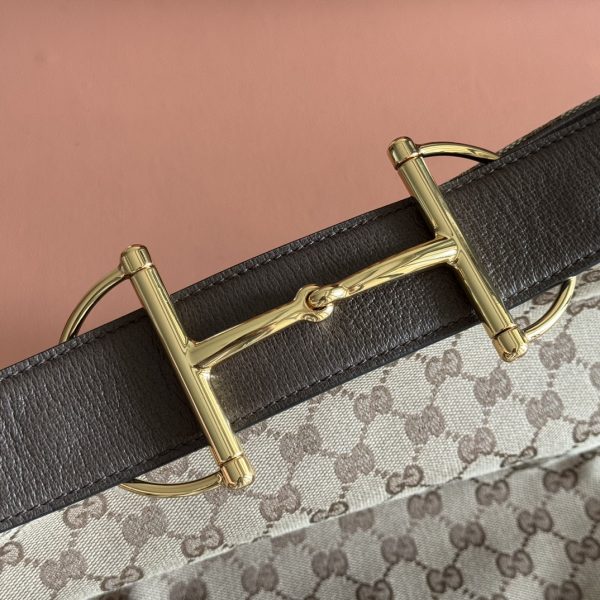 i1758881746_4891_8 The Gucci Beatrix handbag collection is crafted with black cowhide material and adorned with iconic horseneck buckle details on the shoulder strap